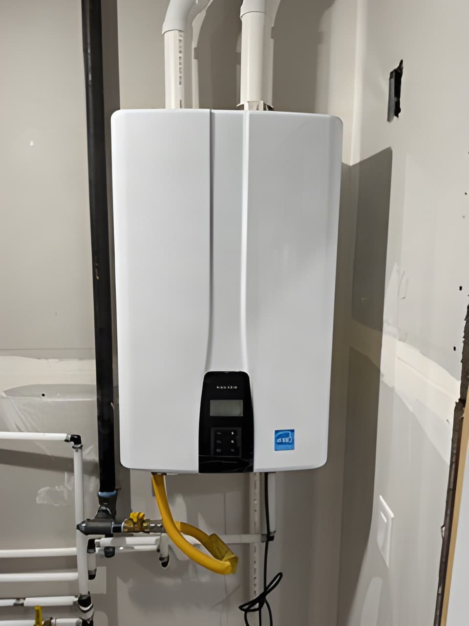 Wall-mounted tankless water heater installed by Drew Davis Plumbing